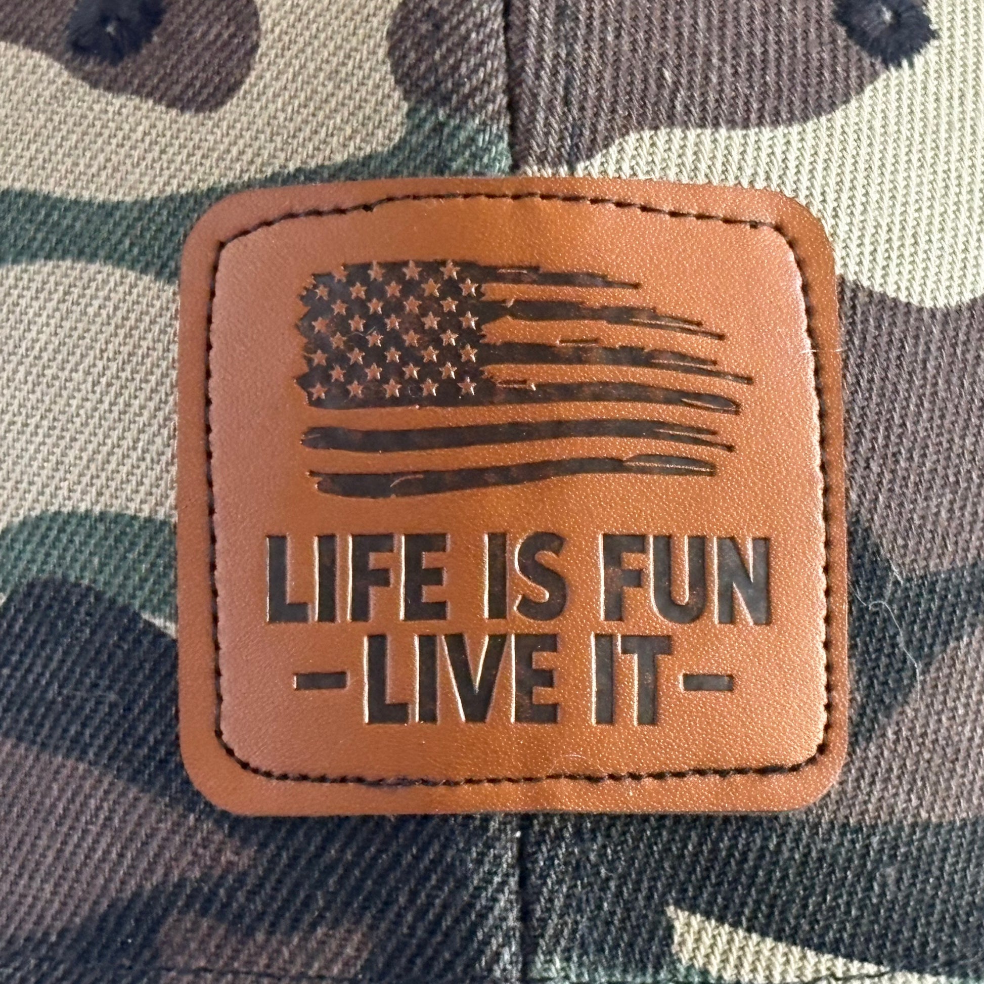 Woodland camo hat leather patch close-up - distressed American flag Life Is Fun Live It