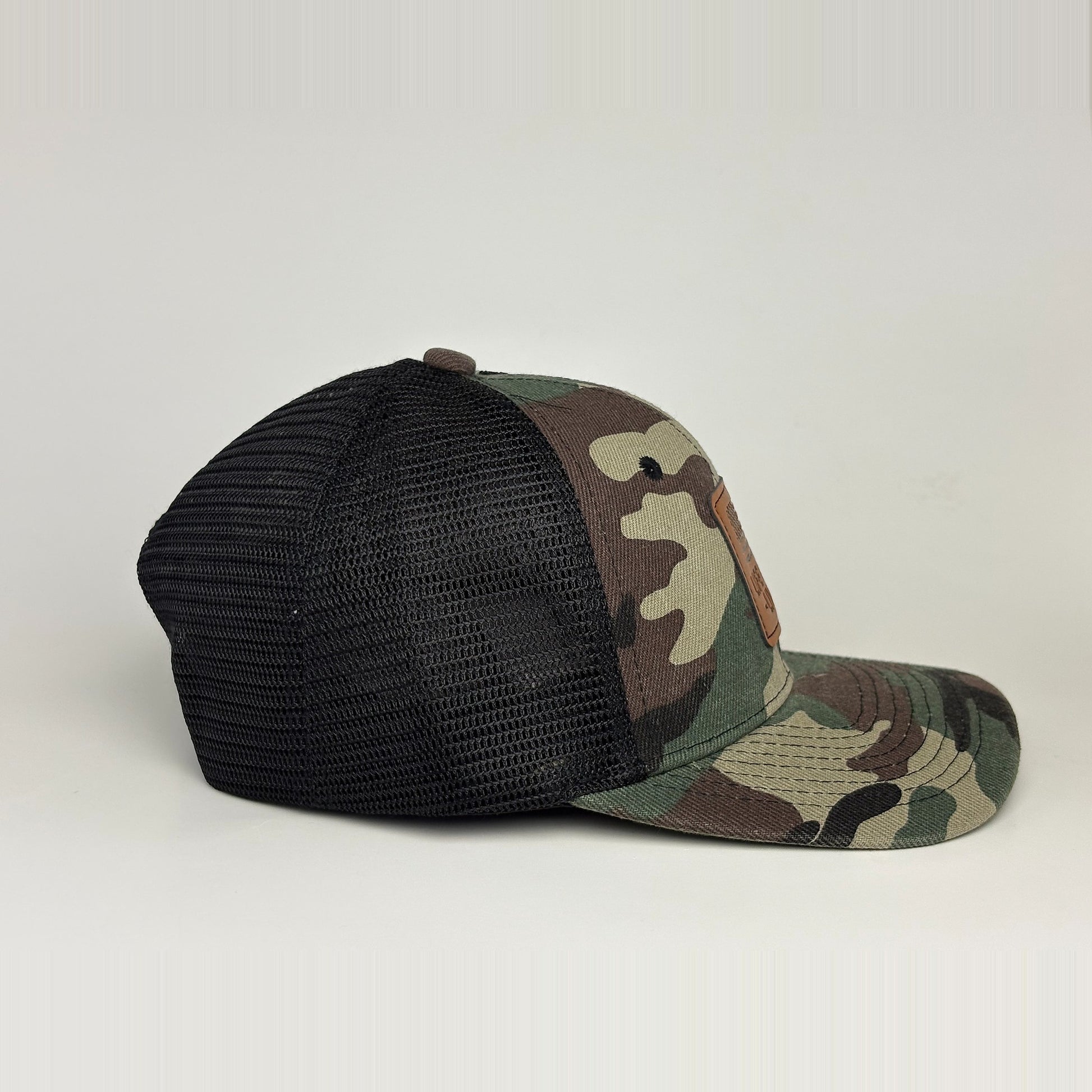 Camo trucker hat side profile - traditional woodland pattern with black mesh back