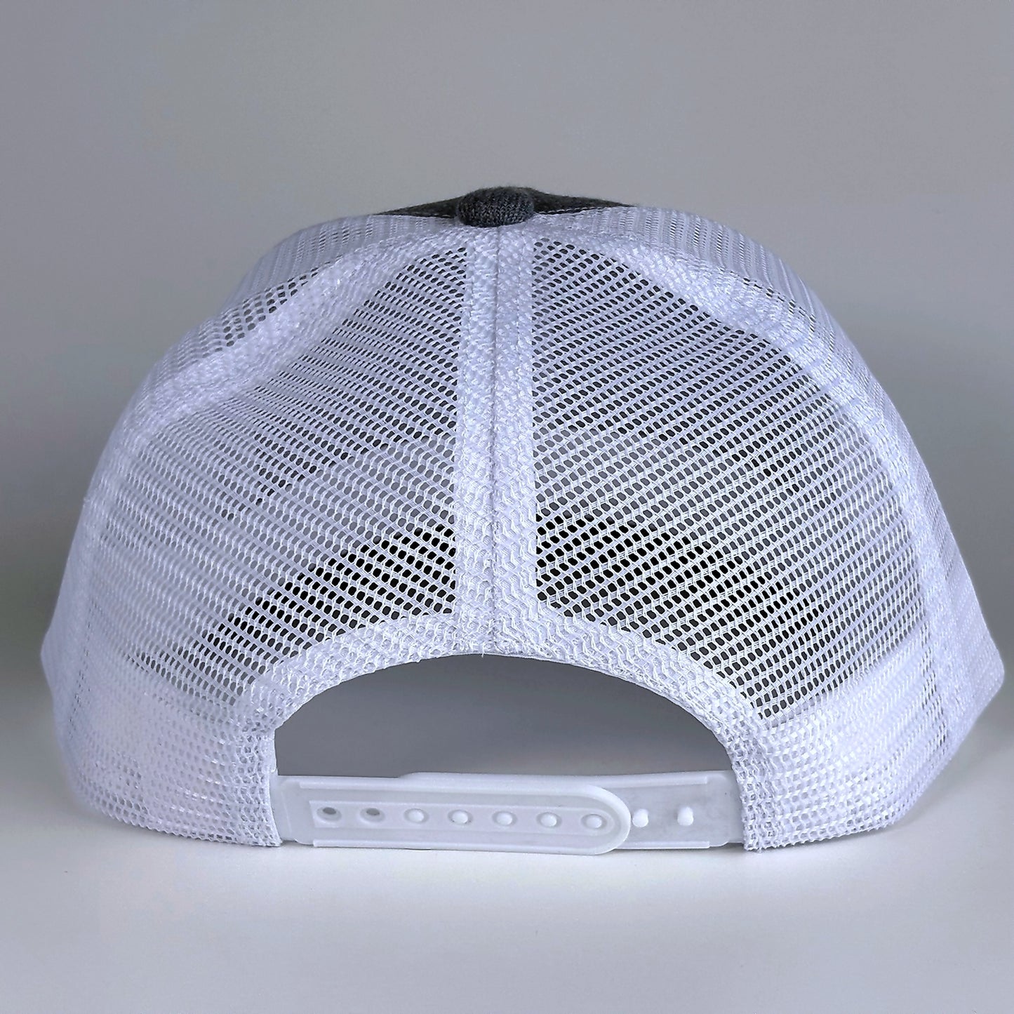 White mesh back with snapback closure on trucker hat