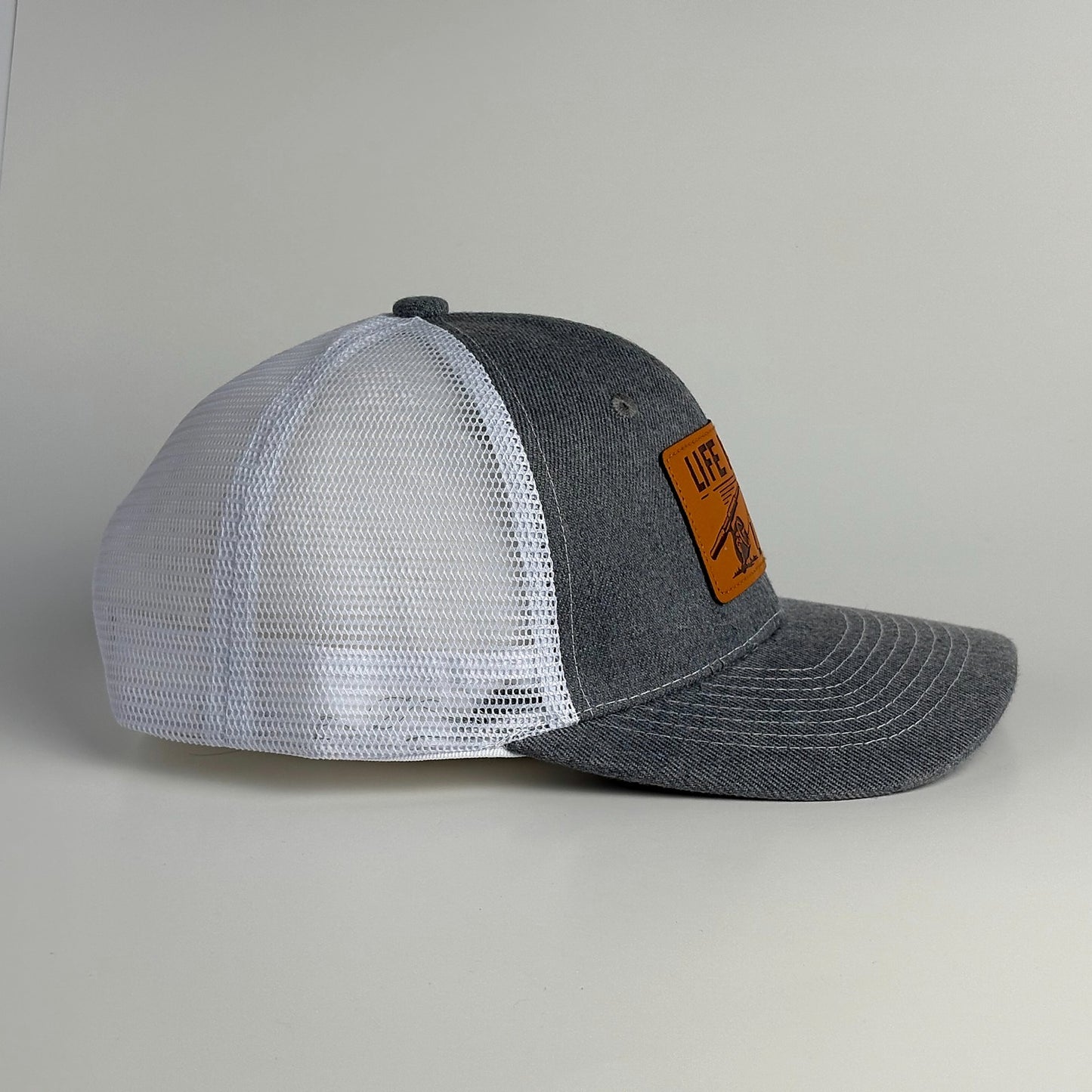 Grey and white mesh trucker hat with snapback side view