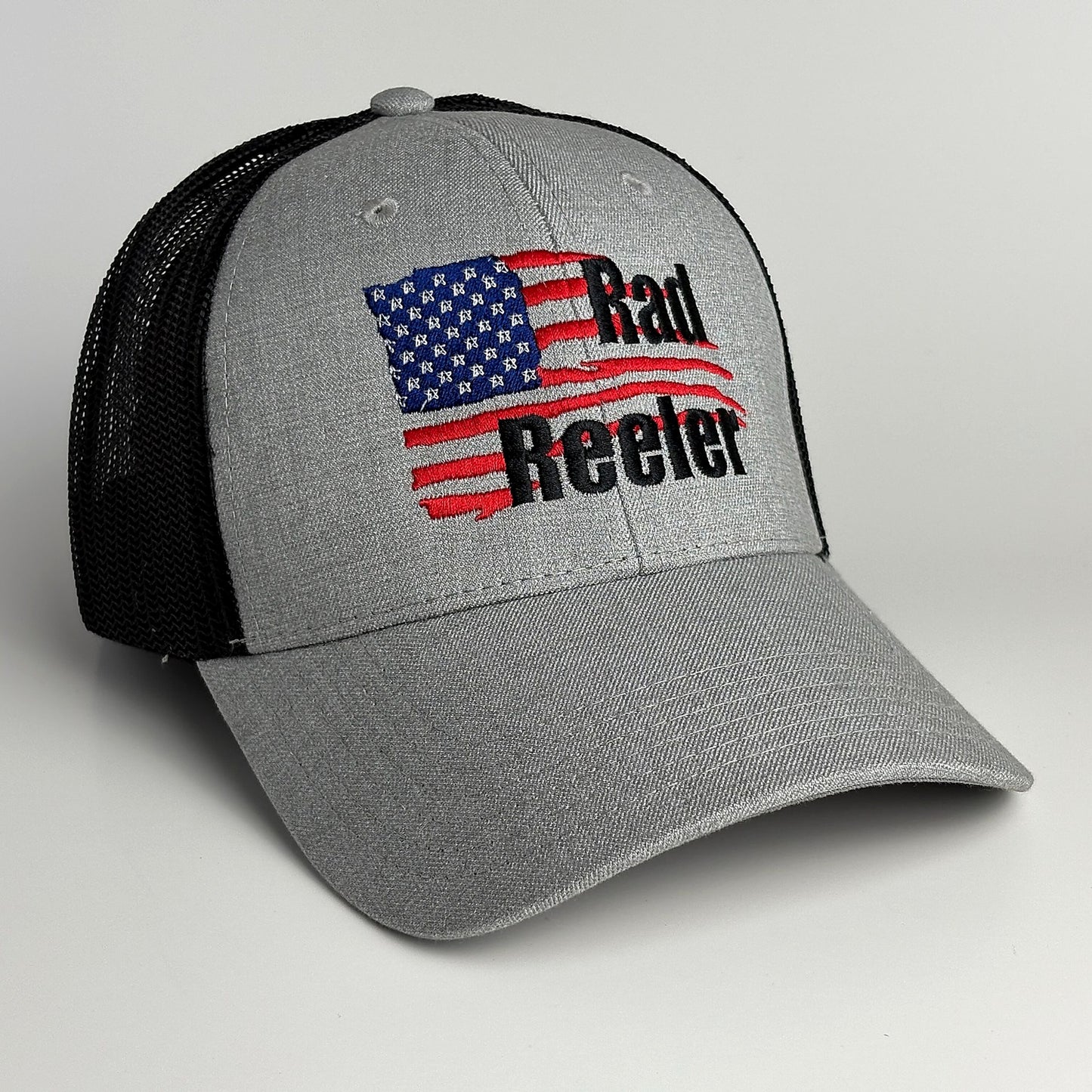 Grey and black mesh trucker hat with American flag Rad Reeler embroidery front view